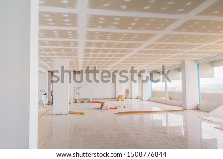 gypsum board ceiling structure and plaster mortar wall painted foundation white decorate interior room in building construction site Royalty-Free Stock Photo #1508776844