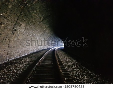 A light in the end of a tunnel. Inside the tunnels of the Circum-Baikal Railway in Siberia. Royalty-Free Stock Photo #1508780423