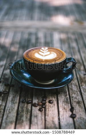 Cup of coffee on wooden table.with selective focus.