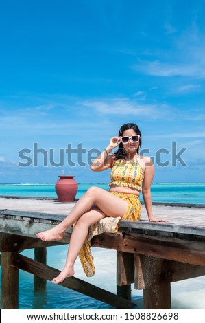 The girl sits on the pier. Vacation and travel concept stock photo