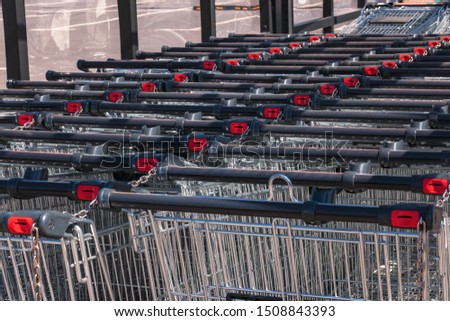 Shopping carts in the store, assembled in a row in the parking lot. Close-up