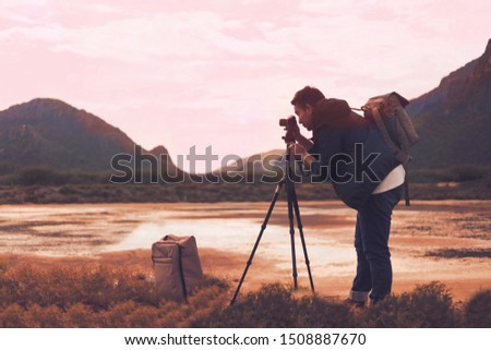 Smart Asian man setting camera for photo shoot at lake Mountain View.