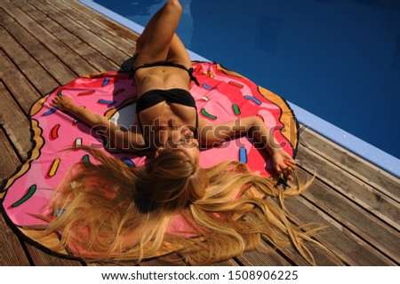 beautiful european blonde girl in various poses in swimsuit