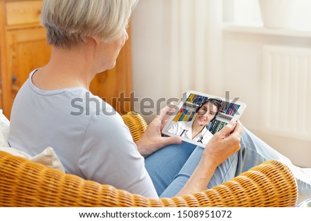 telemedicine concept, old woman with tablet pc during an online consultation with her doctor in her living room Royalty-Free Stock Photo #1508951072