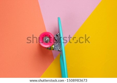 Trendy hipster skateboard on colored background. Minimalism concept. Youth lifestyle.