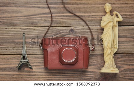 Tourism concept. Traveler background. Travel around the world, flat lay style. Souvenirs, retro camera on wooden background
