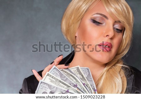 Business woman considers earned money. Close-up photo.