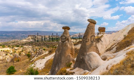 "Three Graces (Üç Güzeller)" rocks. Fairy chimneys of Cappadocia. Shaped rocks. Natural rock cavity. Geological structures. Ancient civilization. Urgup - Goreme region. Nevsehir, Turkey. Royalty-Free Stock Photo #1509038213