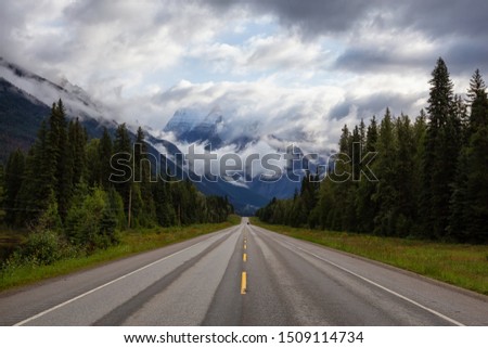 Beautiful View of Yellowhead Highway with Mount Robson in the background during a cloudy summer morning. Taken in British Columbia, Canada. Royalty-Free Stock Photo #1509114734