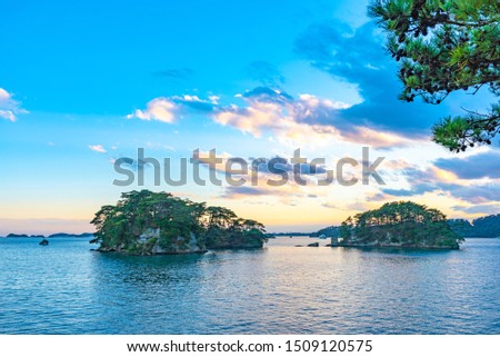 Matsushima Bay in dusk, beautiful islands covered with pine trees and rocks. One of the Three Views of Japan, and is also the site of the Zuigan-ji, Entsu-in and Kanrantei. in Miyagi Prefecture, Japan Royalty-Free Stock Photo #1509120575