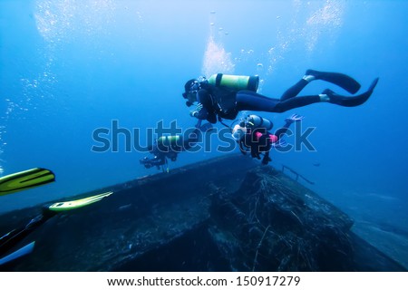 Divers and Marine shipwreck  Royalty-Free Stock Photo #150917279