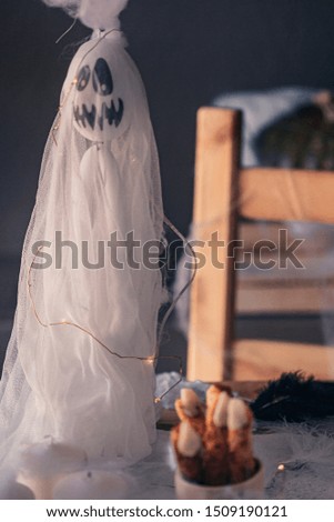 Spooky Halloween decoration with different pumpkins, light, spiders. Halloween table decoration