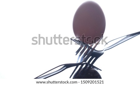 Eggs and fork on black background.