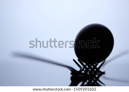 Eggs and fork on black background.