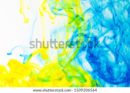 yellow blue ink in water isolated on white background 