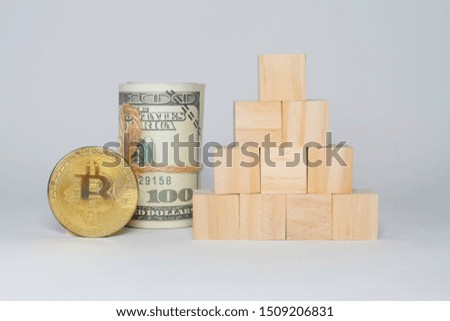 A picture of Bitcoin and cash with copy space wooden block.