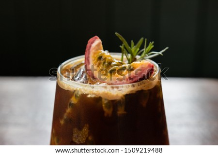fusion drink menu. iced black coffee with passion fruit on top Royalty-Free Stock Photo #1509219488