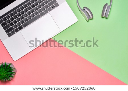blank notebook page on pastel colored background office desk with different objects