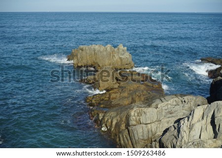 Rocky beack with blue ocean waves