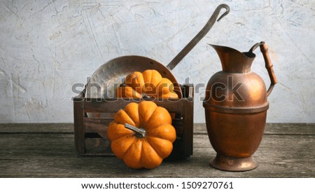 Autumn seasonal cooking concept with pumpkins and kitchen utensils. Front view