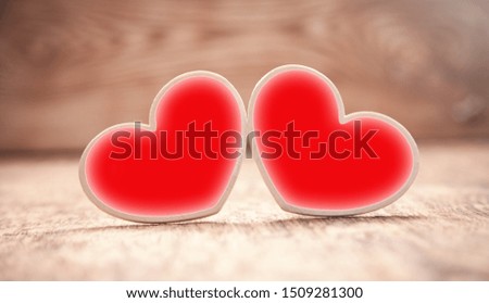 Wooden red hearts on wooden table.