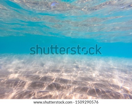 Clear water. underwater background with sandy sea bottom.