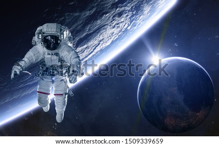 Astronaut on background of planets of deep space. Science fiction. Elements of this image furnished by NASA