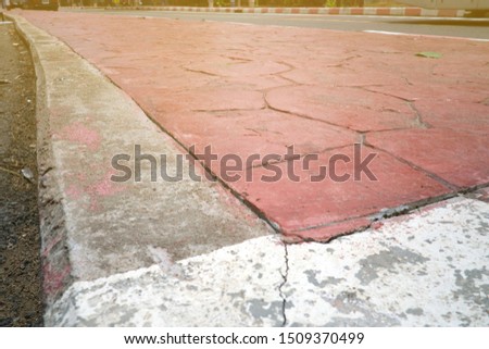 Close up of red paint footpath, Walkway in thailand