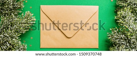 paper envelope, christmas tree branches on green background with confetti. new year concept. Banner for web design. Greeting card, xmas celebration 2020. Flat lay, template, top view, copy space