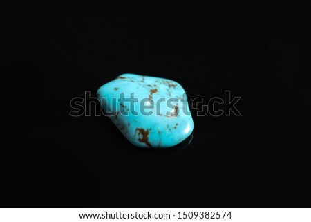 Beautiful light turquoise gemstone on black background Royalty-Free Stock Photo #1509382574