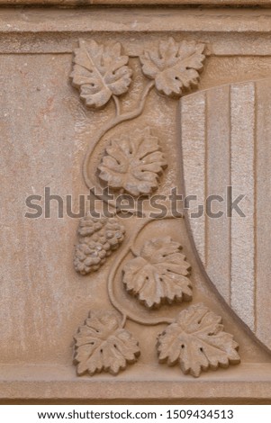 Elements of architectural decoration of buildings, stucco patterns with flowers and faces, gypsum ornaments and wall textures. On the streets in Barcelona, ​​public places.