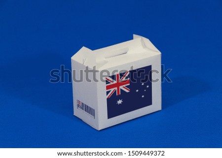 Australian flag on white box with barcode and the color of nation flag on blue background. The concept of export trading from Australia, paper packaging for put products.