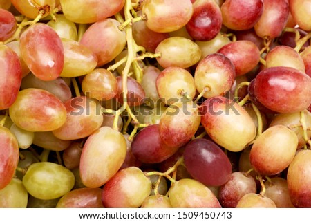 Fresh ripe juicy grapes as background, top view