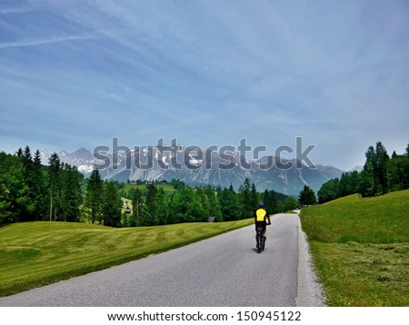 Austria,Alps-outlook of the cyclist on the road,in the background is the Dachstein
