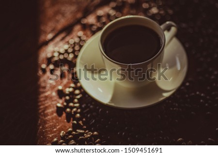 Coffee cups and coffee beans in the morning atmosphere. Soft focus,motionblur 