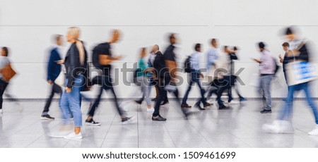 Anonymous blurred crowd on the go at a business trade fair