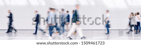 Beautiful motion blur of crowd of people walking. Early morning rush hours, busy modern life concept. Ideal for websites and magazines layouts