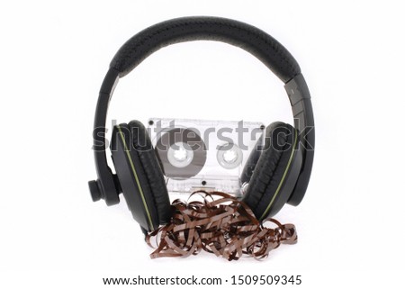 Retro compact cassette and headphones conceptual photo. Vintage audio player, Blank audio tape and headphones on white background