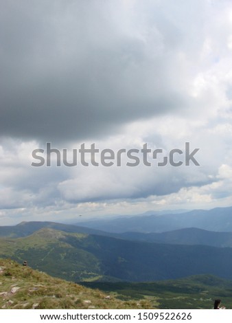 The picture was taken from the mountain Goverla. The photo view of the clouds and the Carpathian Mountains.