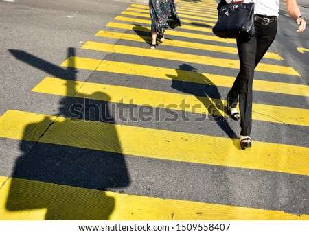 Street photography with people crossing the street in Geneva center, Switzerland