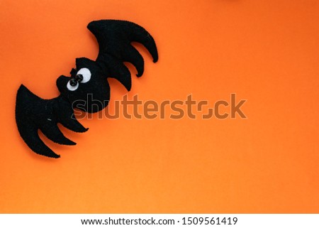 cute halloween concept. hand made kids toy. bat  on orange background. top view