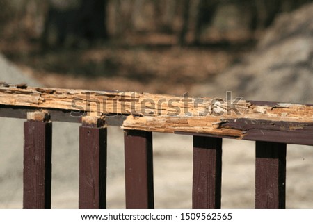 heavily rotted and chipped wood railings