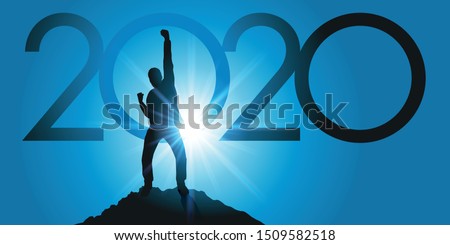 Greeting card 2020 showing a satisfied man raising his fist as a sign of victory after reaching his goal on reaching the top of a mountain.