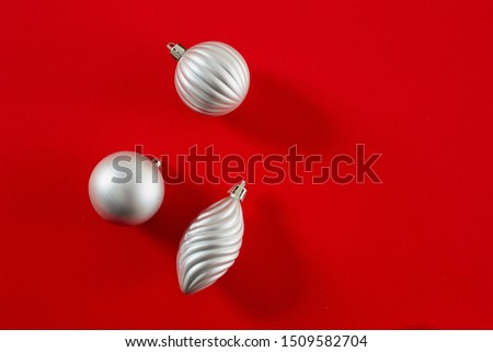 flat lay Silver Christmas Ball on red background, copy space for text