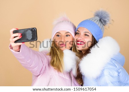 Selfie time. Emotional women in jackets. Friends hang out together. Female clothes shop. Modern trendy female outfit. Gorgeous girls makeup faces cuddling. Female fashion. Girls friends having fun.