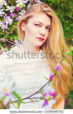 beautiful blond girl in magnolia blossom