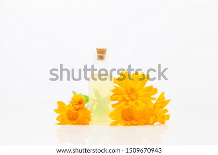 Essence of flowers on White background in a  beautiful glass bottle