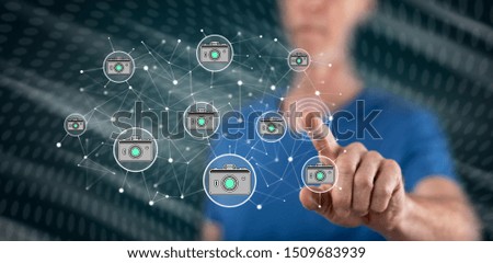 Man touching a photo sharing concept on a touch screen with his finger