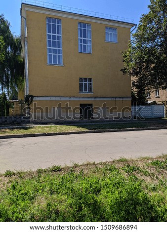 House with Windows white and green grass