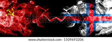 Communist vs Faroe Islands abstract smoky mystic flags placed side by side. Thick colored silky smoke flags of Communism and Faroe Islands